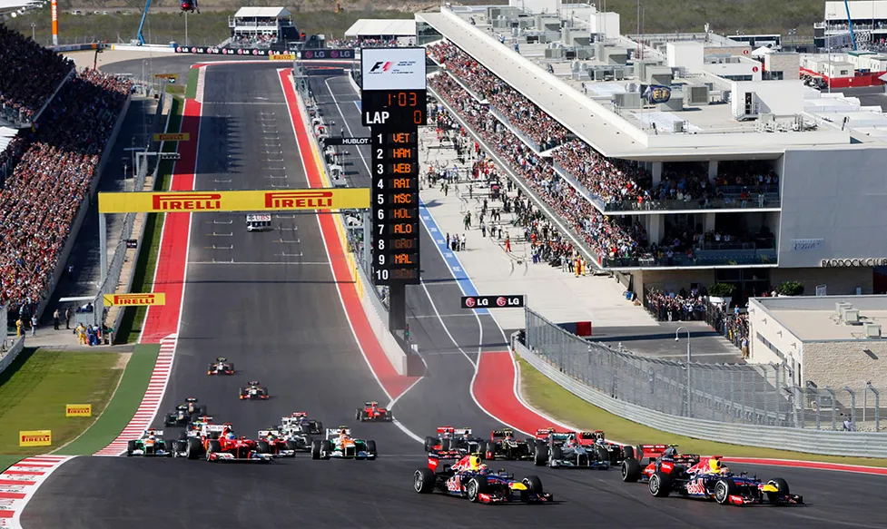The F1 cars speed to the first corner past the start line at the Austin Grand Prix race track