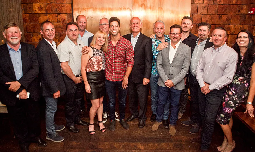 F1 drive Daniel Ricciardo takes a photo with Ultimate Driving Tours crew and guests in Austin, Texas