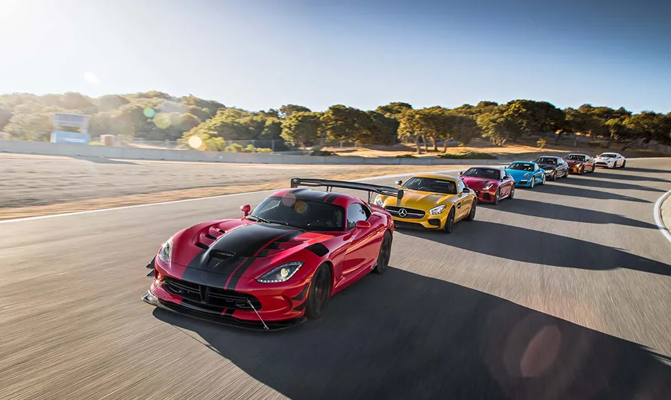 A yellow Chevrolet Corvette with black stripes on a race track in the USA