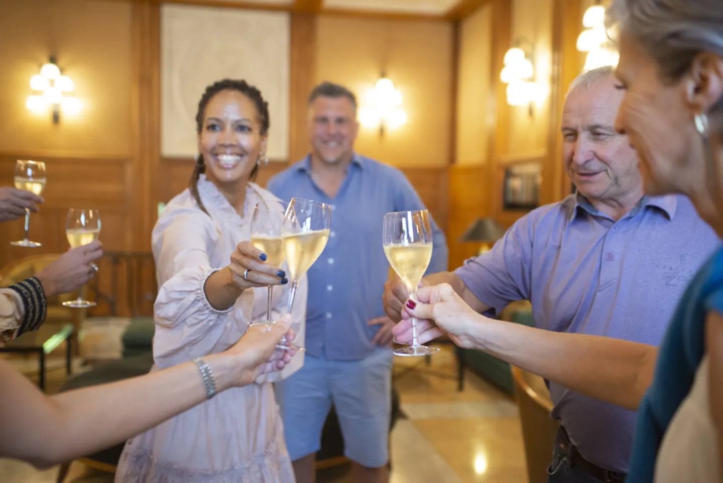 Couples drinking champagne and smiling on a luxury Swiss Alps holiday package