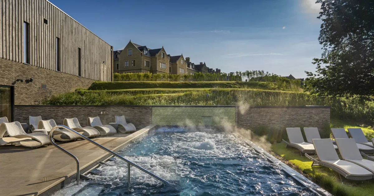 An outdoor spa bubble vigorously in the manicured grounds of South Lodge, Sussex, United Kingdom.