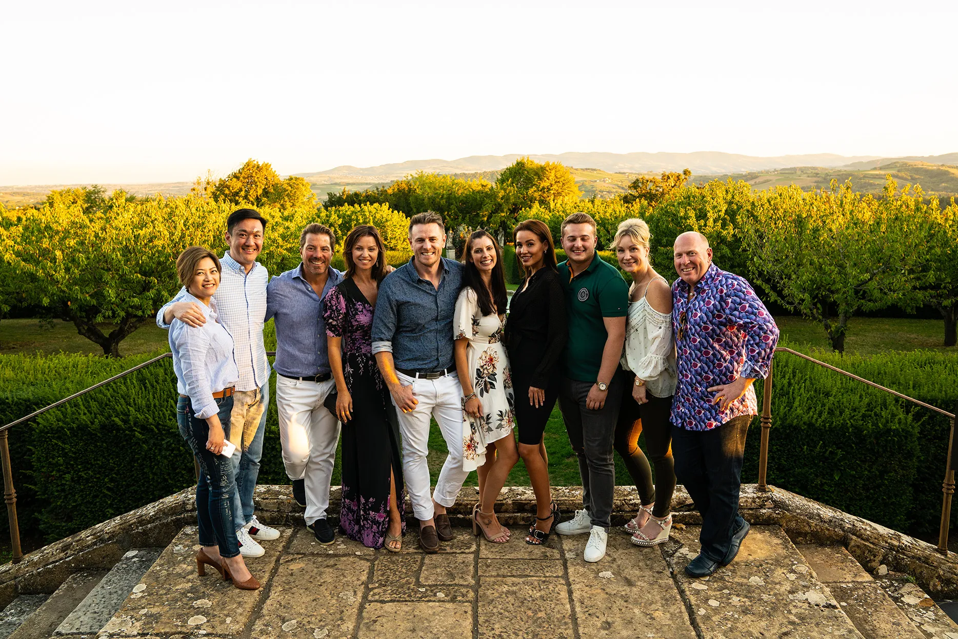 A group of people standing in front of a vineyard in France