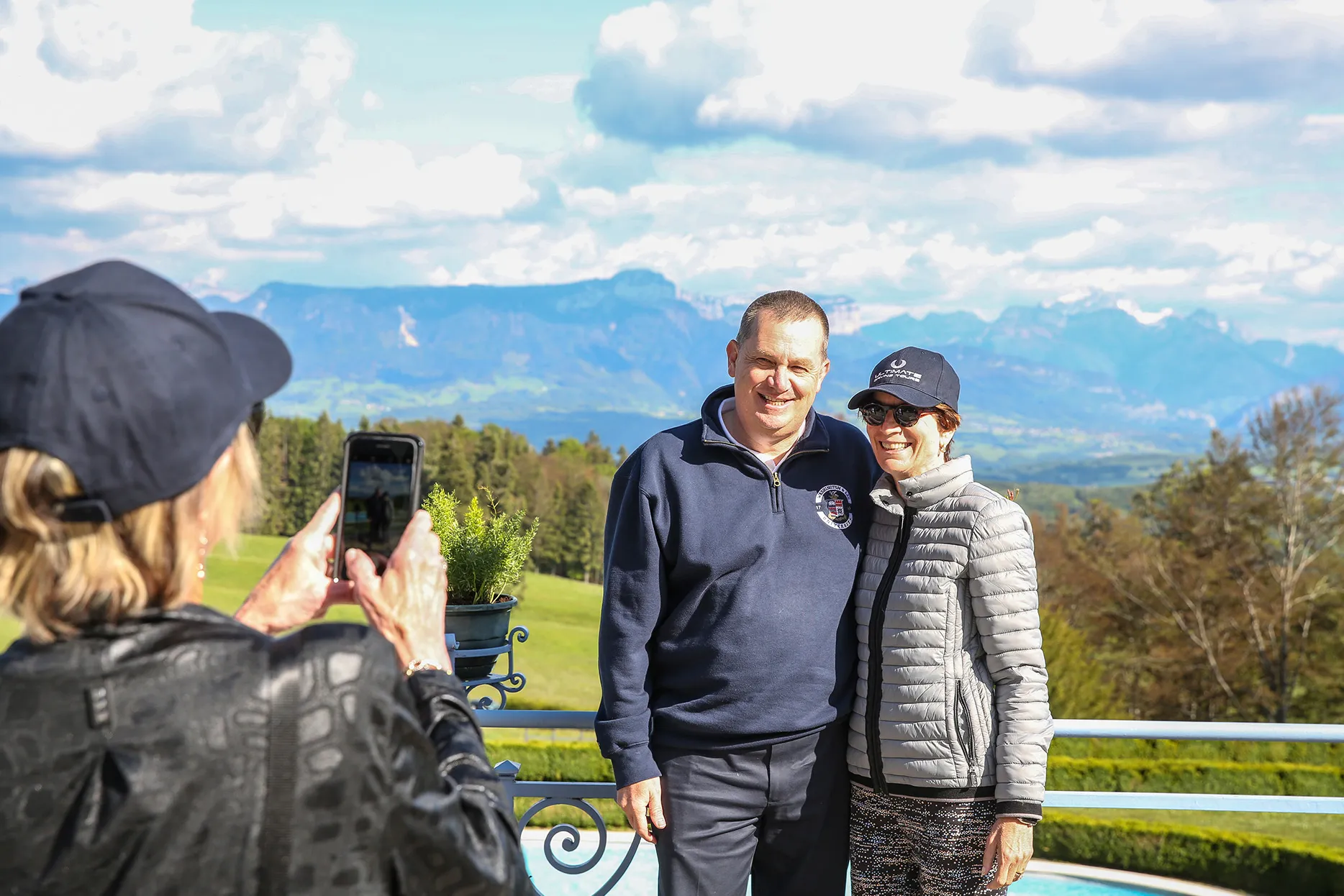 A couple having their photo taken with the French countryside in the background