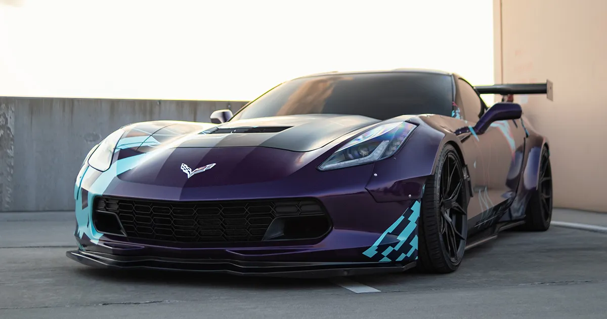 A purple Chevrolet Corvette with racing decals.