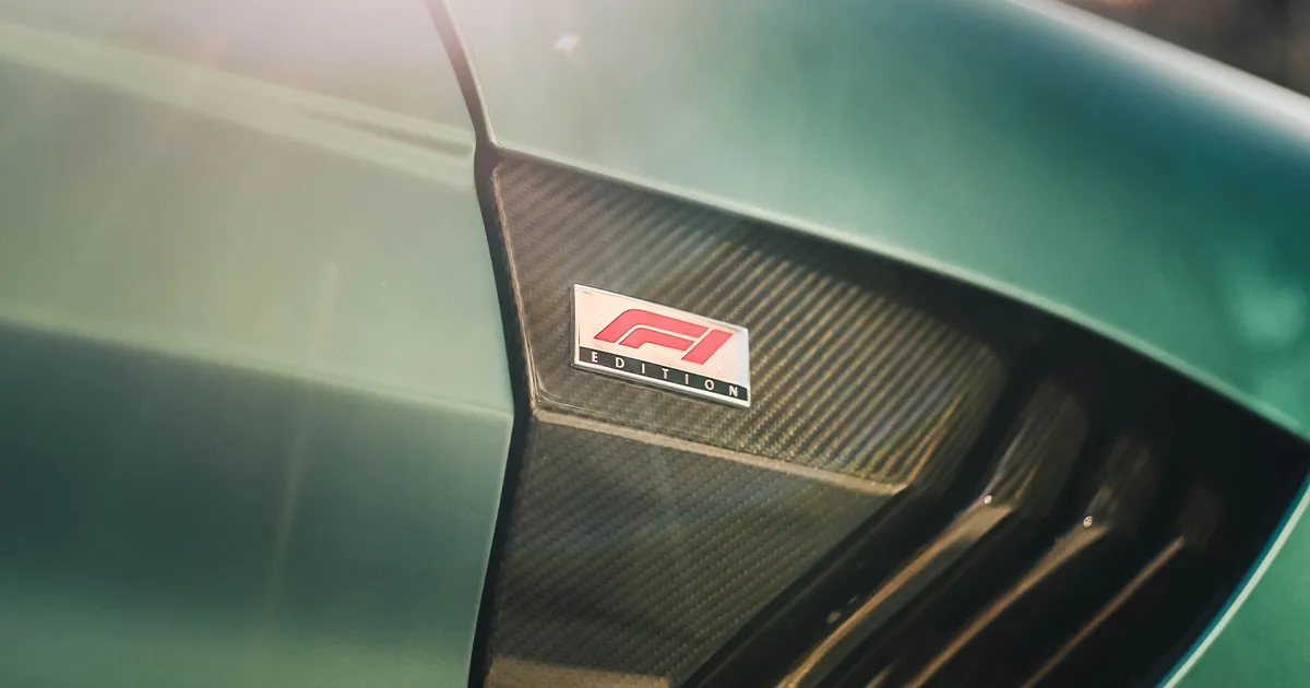 A close up of a carbon fibre panel on a teal coloured Aston Martin with the words ‘F1 Edition’.