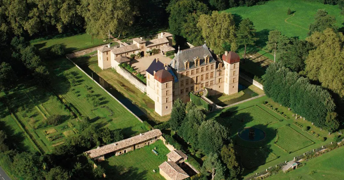 Château de Fléchères and its grounds seen from above on a sunny day.