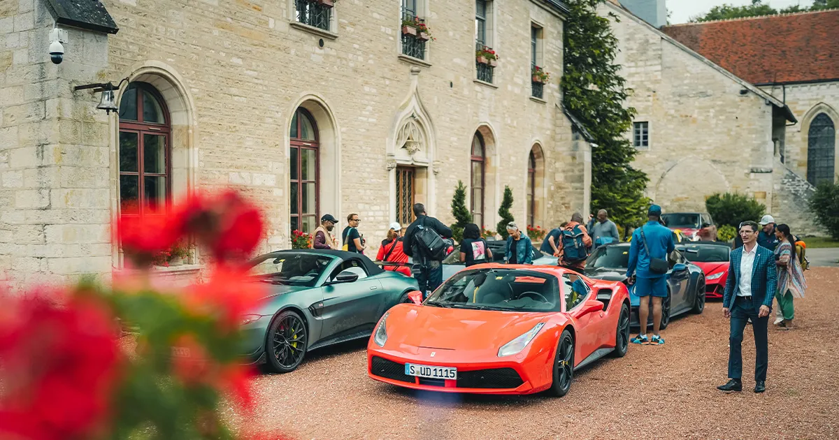 The Ultimate Driving Tours fleet of supercars parked outside a huge French manor house.