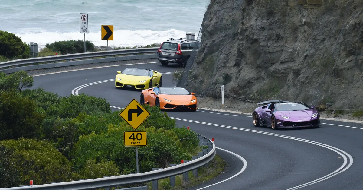 Fleet of Lamborghini Supercars driving the Great Ocean Road
