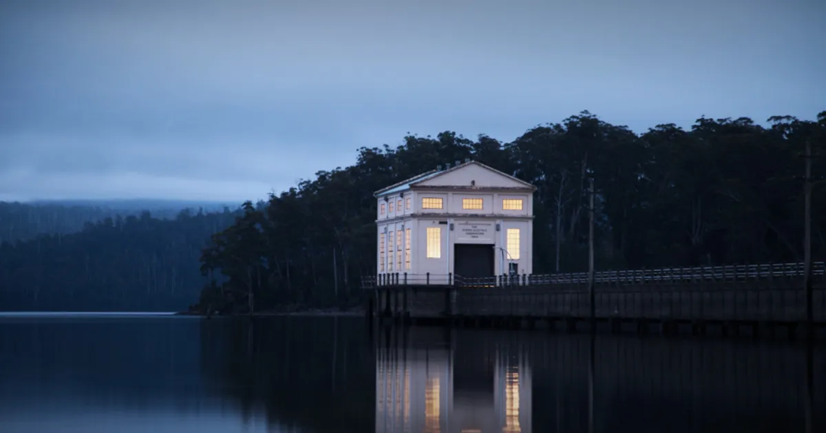 Pumphouse Point Hotel is illuminated during an evening on Lake St Clair in Tasmania. 