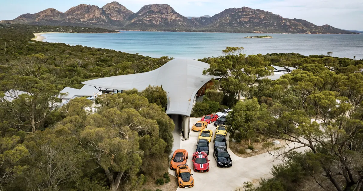 An elevated shot of Saffire Freycinet Resort, Tasmania, with the Ultimate Driving Tours fleet outside.