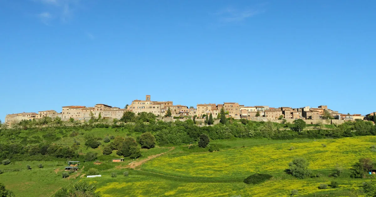 A hilltop town in Tuscany perched above forests and paddocks.