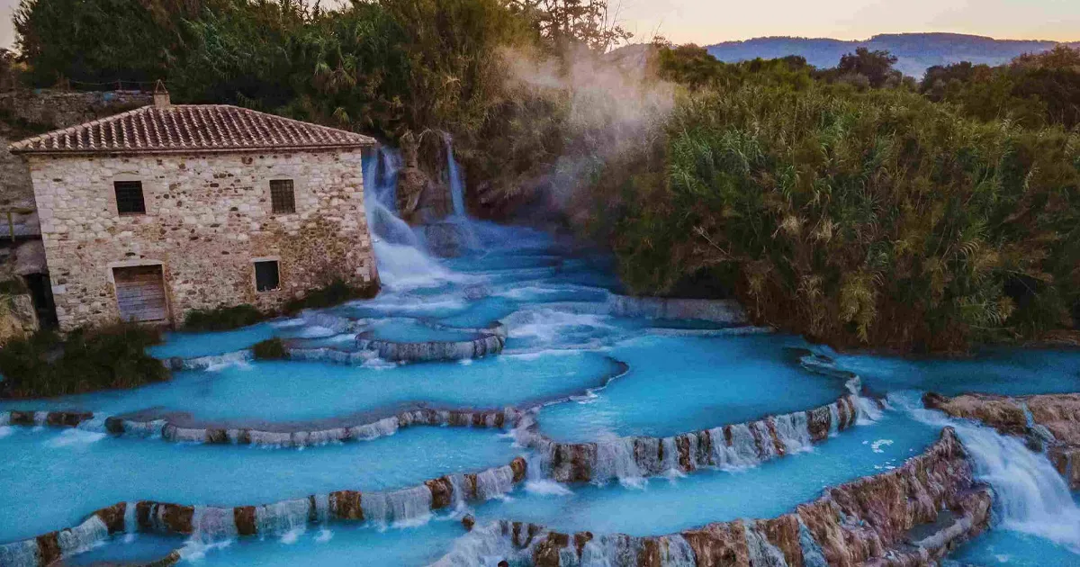 Natural hot waterfalls and old stone buildings of Saturnia, Tuscany