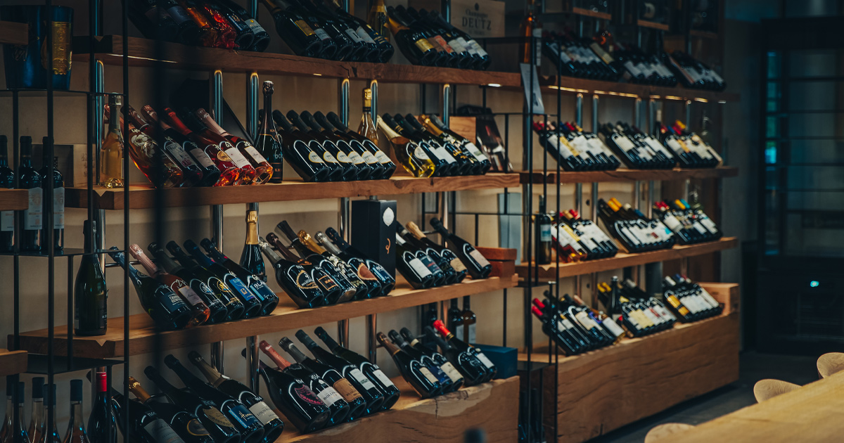 Wine bottles arranged neatly on timber racks with elegant lighting