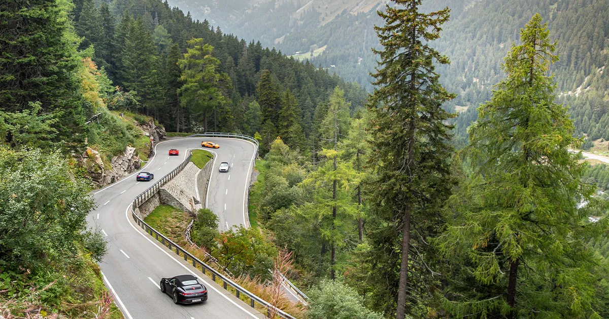A fleet of supercars descends a twisting section of the B500 road in the Black Forest