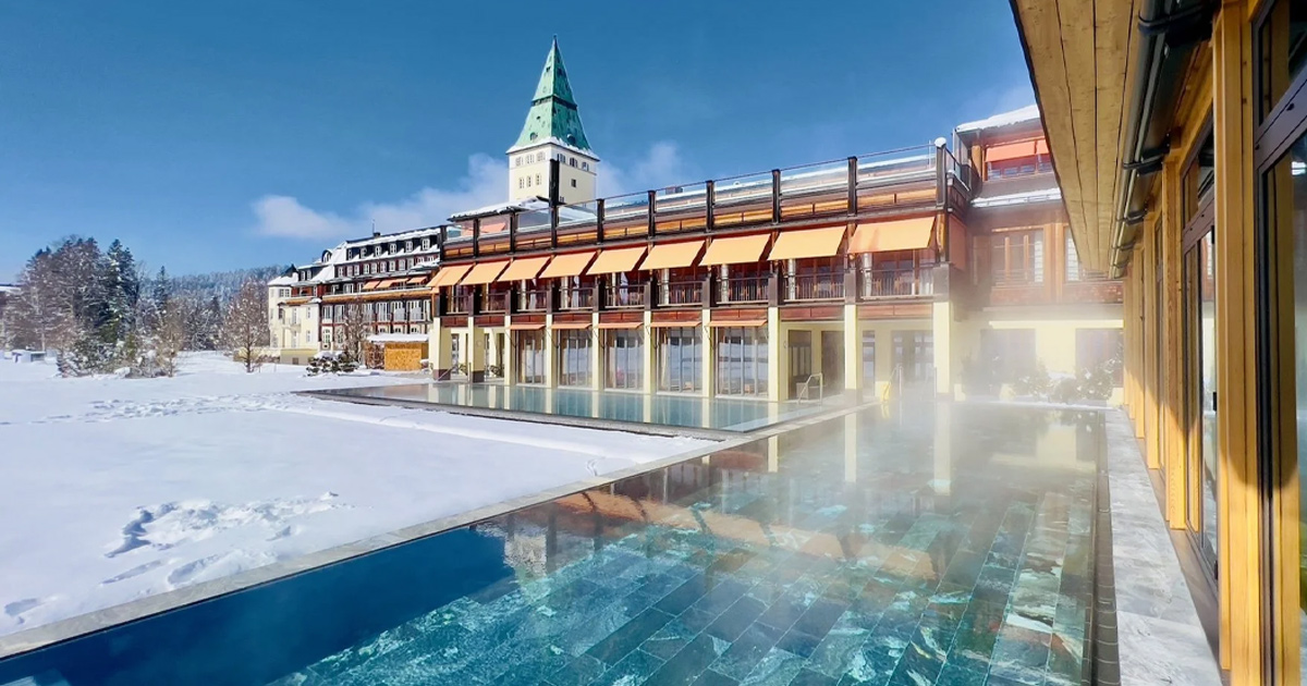 Steam rising from an outdoor thermal pool at a luxurious alpine resort.