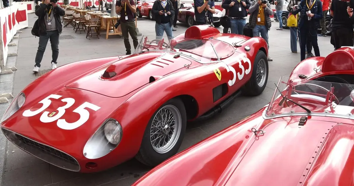 Two vintage racing Ferraris parked next to each other.