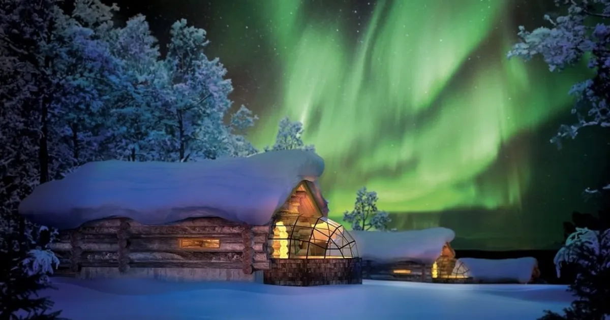 The Aurora Borealis illuminates the sky over Kakslauttanen Arctic Resort, Lapland, Finland