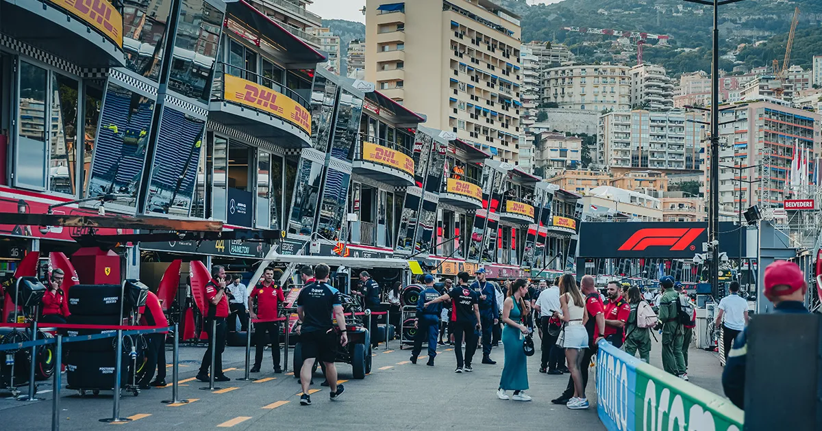 The pit lane at Circuit de Monaco is filled with team members and spectators during the Grand Prix.