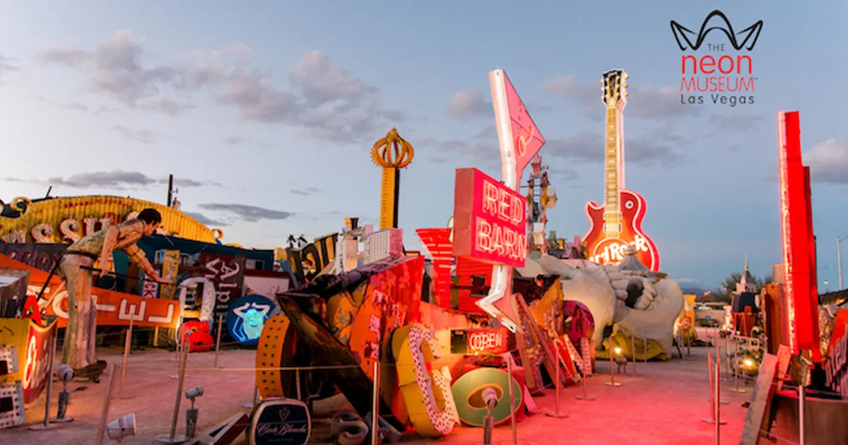 A large and diverse collection of neon signs in an outdoor setting.