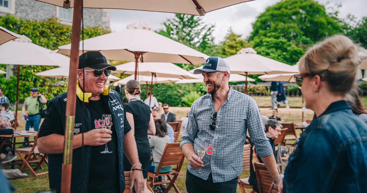 Anthony Moss of Ultimate Driving Tours shares a laugh with guests at Goodwood