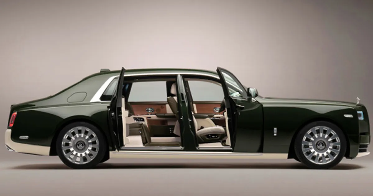 A green Hermes edition Rolls Royce Phantom with its doors swung open to reveal the interior.