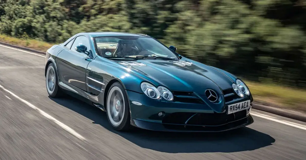 A teal McLaren Mercedes SLR roaring along a highway