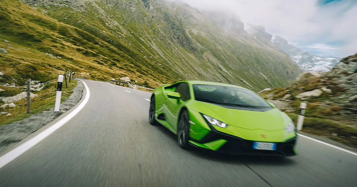 A green Huracán captured with motion blur as it races towards the camera