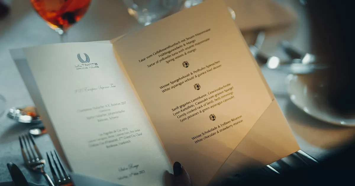 A dinner menu for a fine dining restaurant adorned with the Ultimate Driving Tours logo.