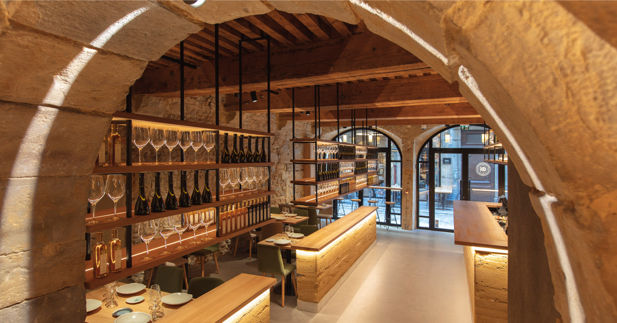 An immaculate display of wine glasses and bottles at Restaurant Paul Bocuse