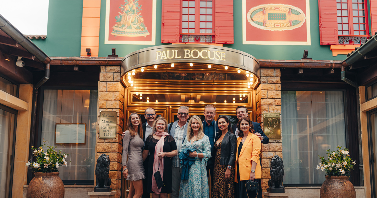 A group of Ultimate Driving Tours guests at Restaurant Paul Bocuse