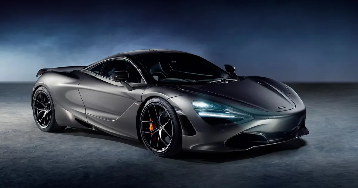 A gunmetal grey McLaren 720S with its LED headlights on