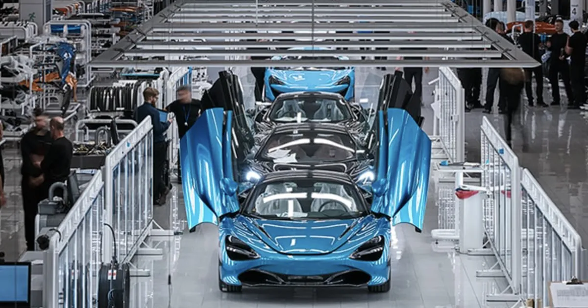 McLaren supercars move along a spotless factory line as workers perform checks and processes 
