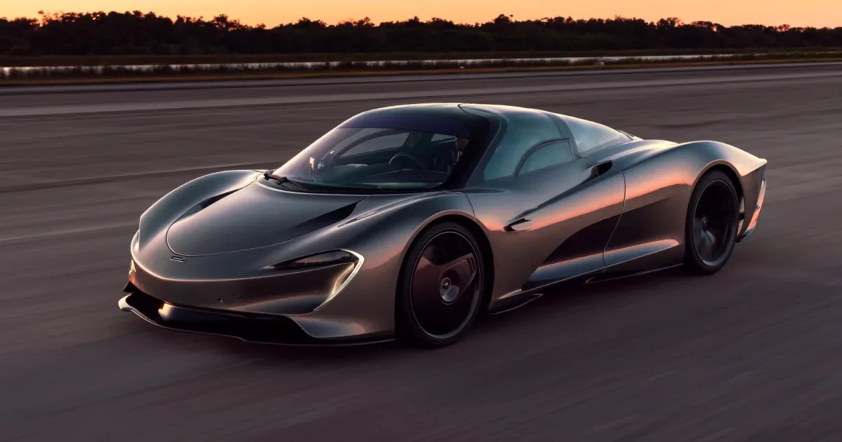 A McLaren Speedtail supercar driving on a closed road at dusk.