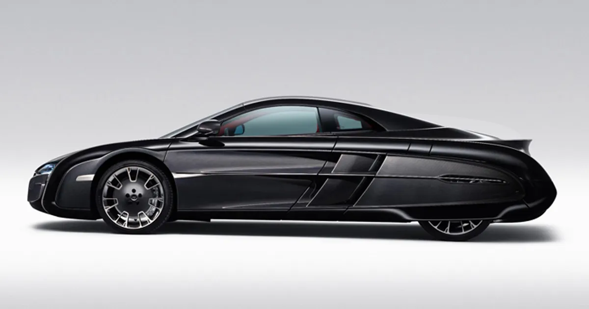 A McLaren X-1 supercar in black with quirky styling including louvred side grates and covered rear wheel