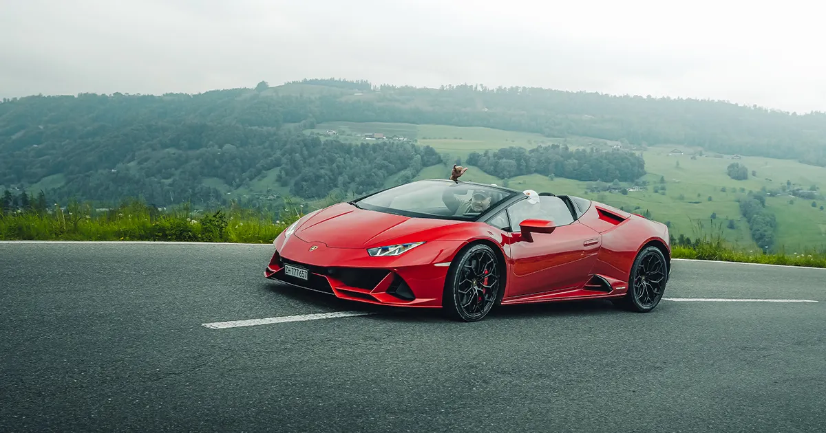 A red Lamborghini Huracán Performante Spyder on a country road