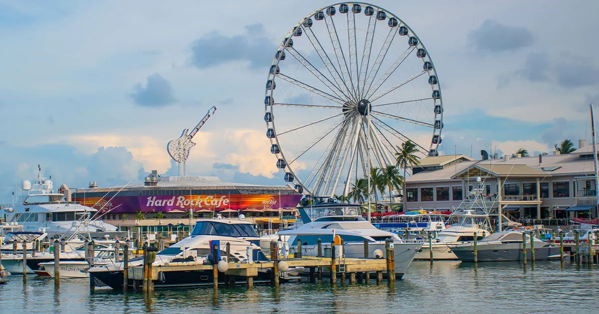The Miami waterfront with boats, Hard Rock cafe and ferris wheel