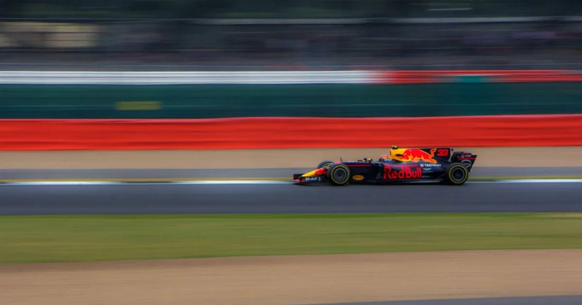 A Red Bull F1 car captured at high speed on a straight with blurred background