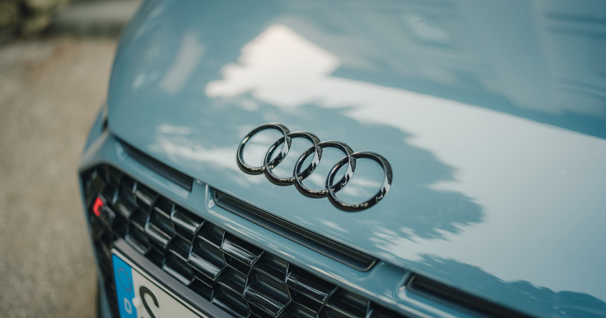 The bonnet of a powder blue Audi R8 with black four rings logo