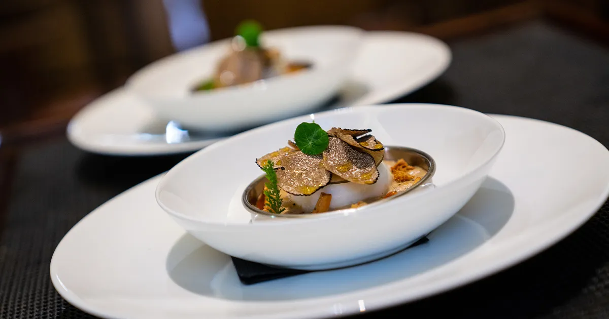 Finely shaved white truffles adorn a delicate meal on an Ultimate Driving Tours luxury holiday.