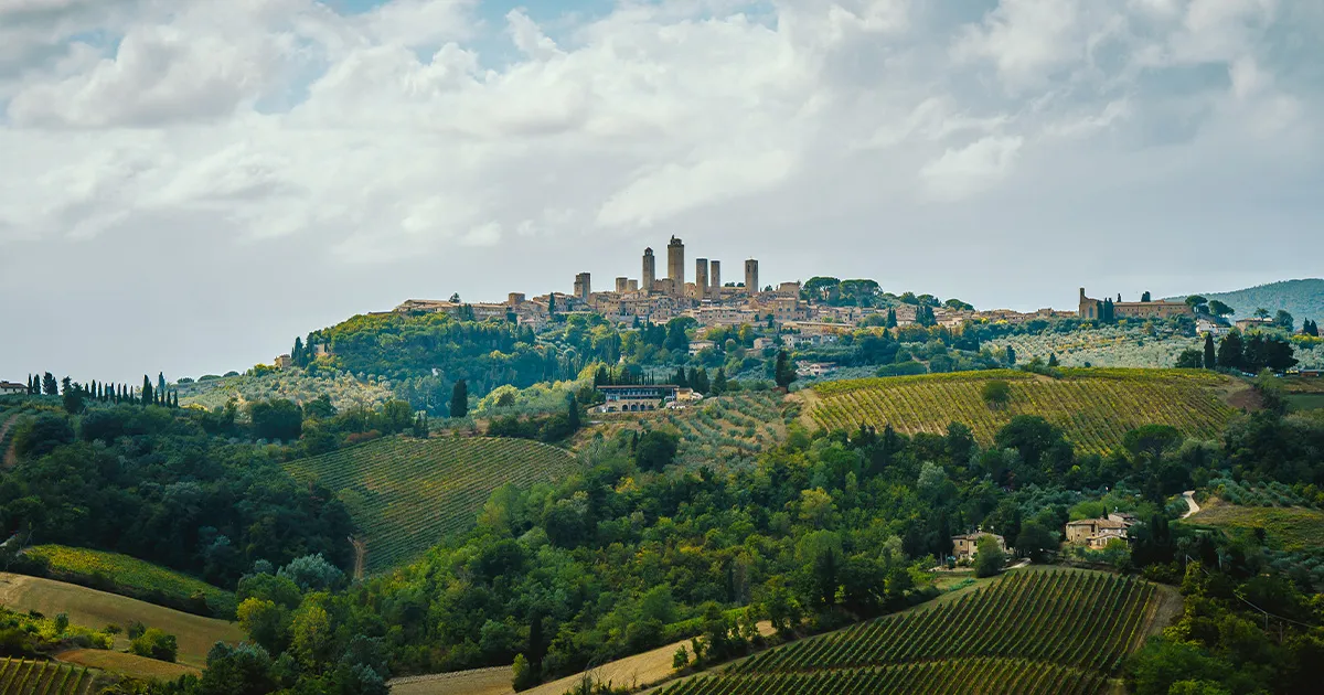 A hilltop town in a lush green valley in Italy.