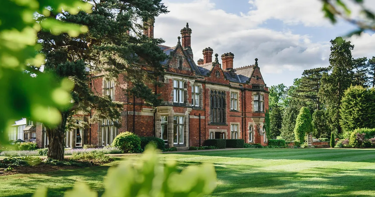 An exterior shot of Rockliffe Hall and its grounds on a cloudy day.