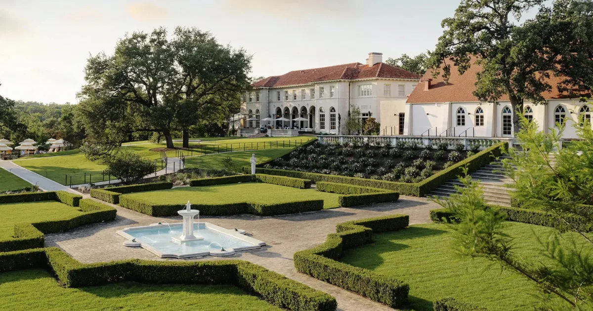 Perfectly kept gardens outside a traditional mansion-style hotel in Austin, the Commodore Perry Estate.