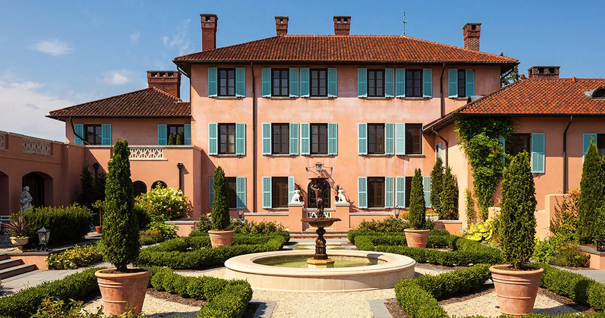 Carefully manicured gardens in a courtyard outside a villa hotel with clay roof tiles.