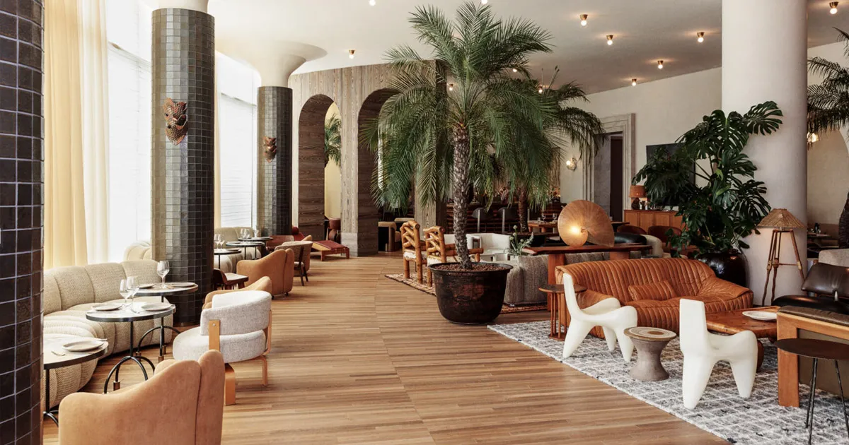 A stylish lounge room with plush leather furniture and tiled walls at the Proper Hotel, Los Angeles.