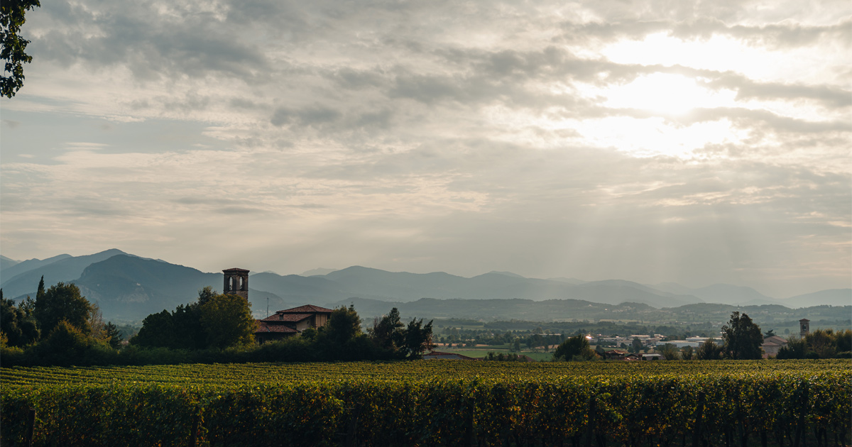 Sun breaking through soft cloud above the Italian countryside
