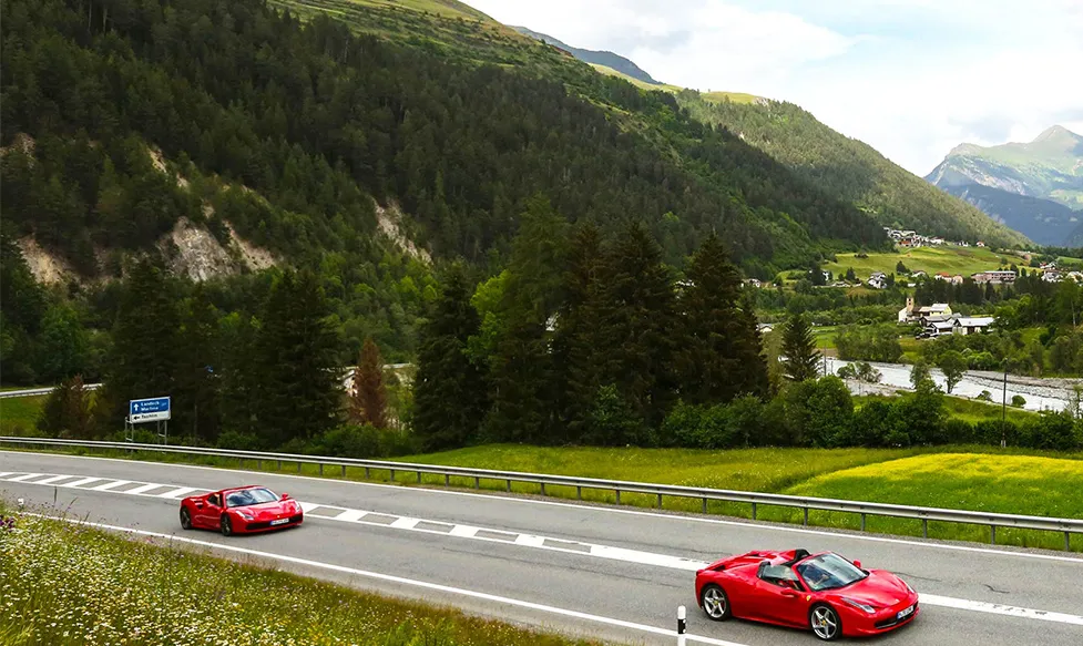 Two red Ferraris stretch their legs in Italy’s rolling hills on an Ultimate Driving Tours luxury escape
