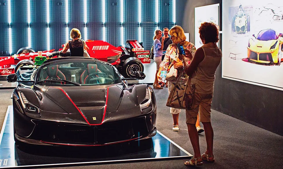 Ultimate Driving Tours&rsquo;; guests take photos of a rare prototype car at Ferrari&rsquo;s famous Maranello factory in Italy