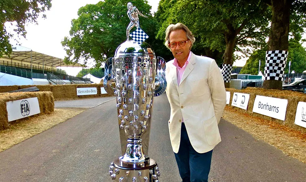 Charles Henry Gordon-Lennox, the founder of Goodwood Festival of Speed, pictured next to a large trophy