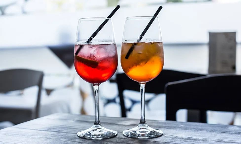 A pair of iced apertifs with straws sit on a table in Milan during an Ultimate Driving Tours Italian driving holiday