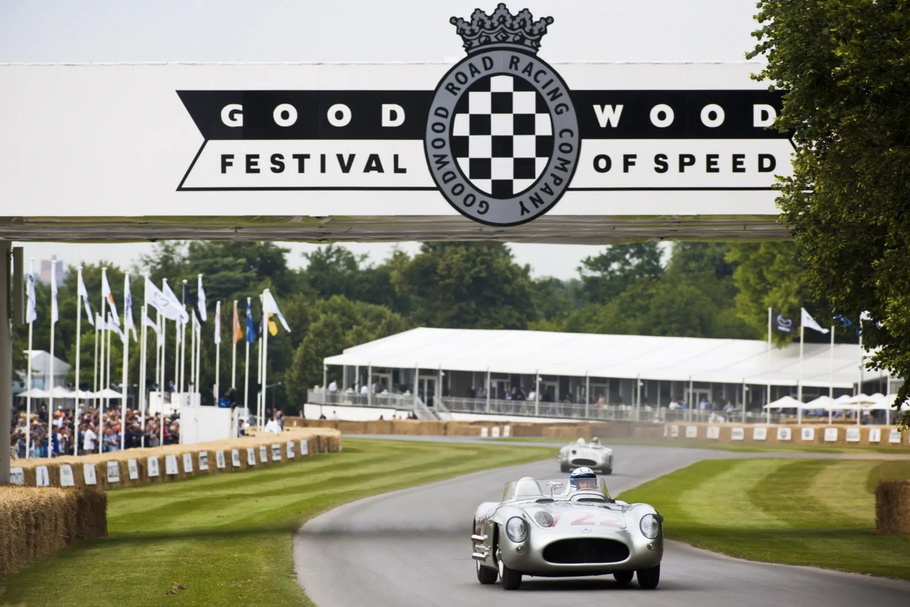 A car passes under the Goodwood Festival of Speed Sign